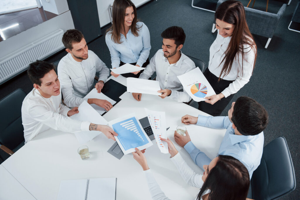 Consulting team reviewing organisational strategy documents together